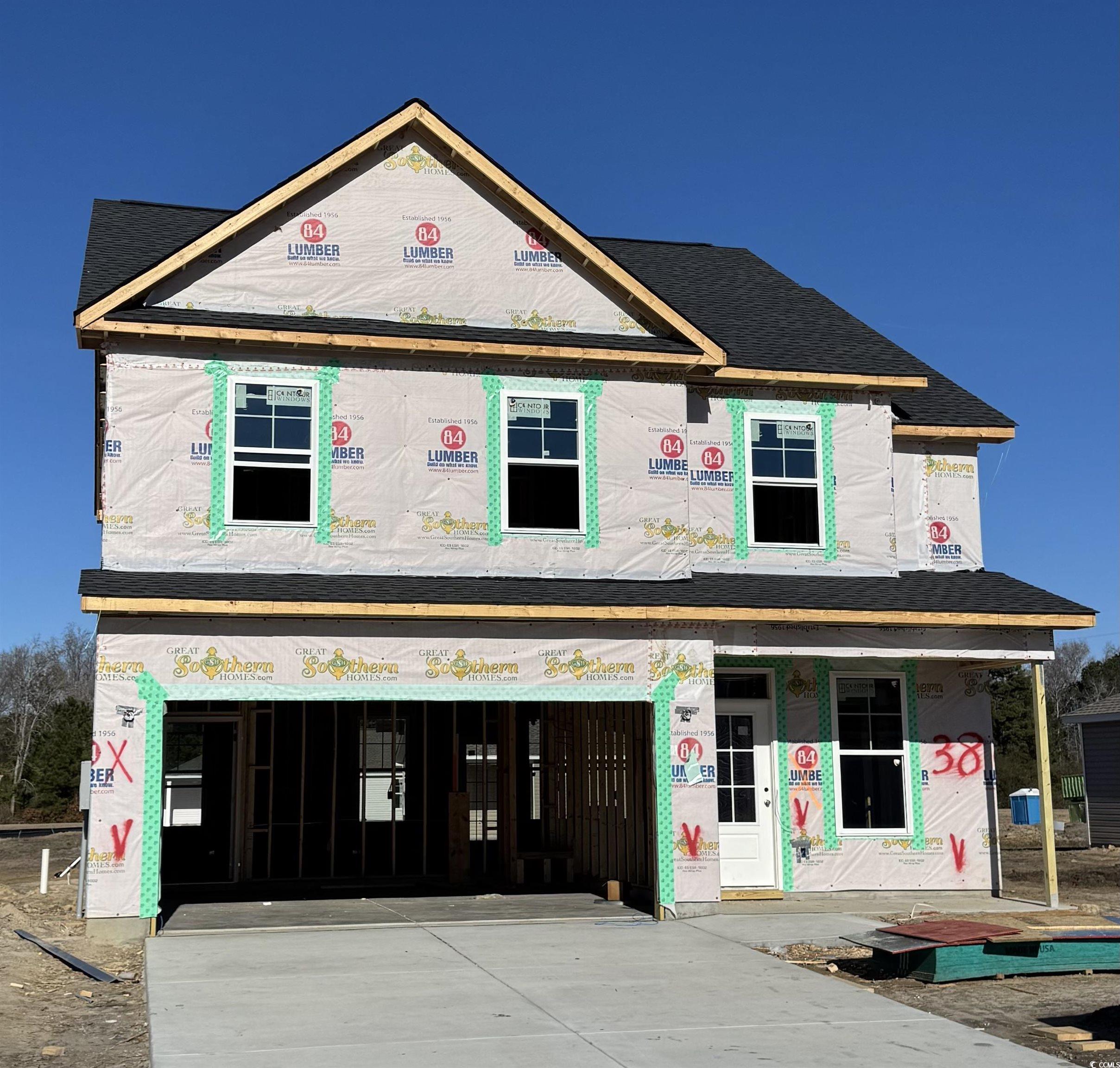 Property in mid-construction with an attached garage, concrete driveway, and roof with shingles