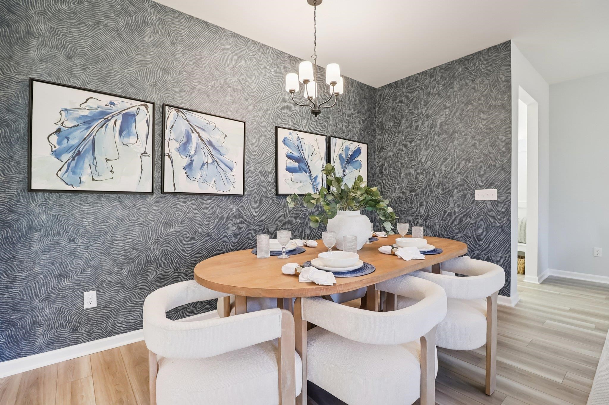 704 Bramble Way Conway, SC 29527 - Photo 4 of 17 Kitchen with brown cabinets, stainless steel appliances, light stone countertops, decorative light fixtures, and light wood-type flooring