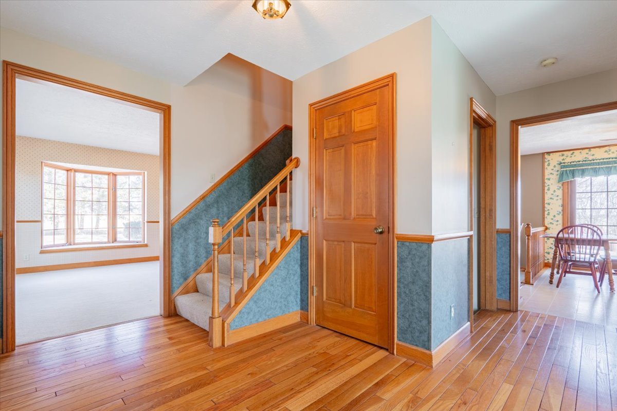21389 North 2875 East Road Lexington, IL 61753 - Photo 12 of 44 a view of an entryway with wooden floor and stairs