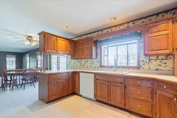 a bathroom with a sink a toilet and shower curtain