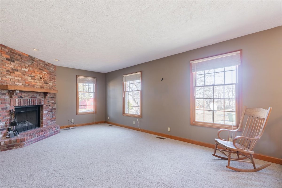 21389 North 2875 East Road Lexington, IL 61753 - Photo 21 of 44 a living room with furniture and a fireplace