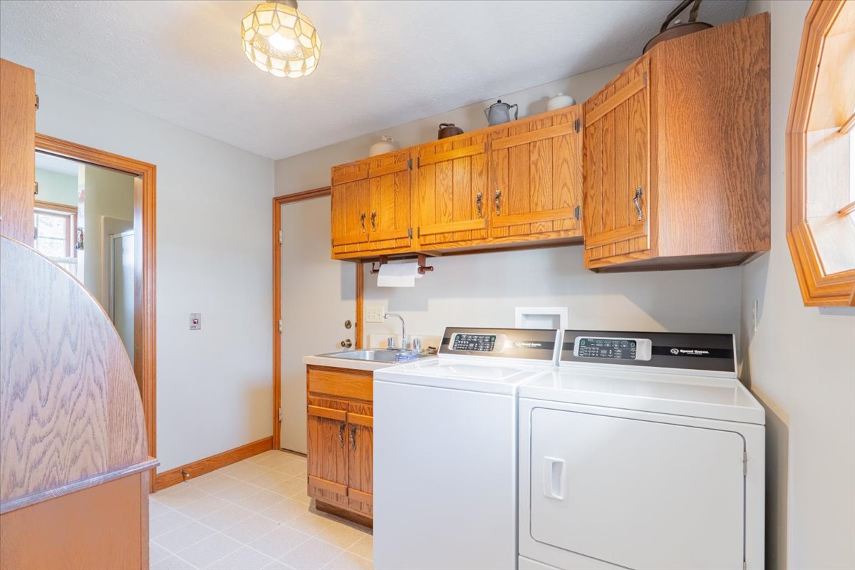 21389 North 2875 East Road Lexington, IL 61753 - Photo 25 of 44 a view of cabinets and utility room with washer and dryer