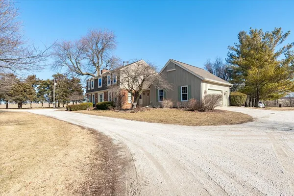 a view of a house with snow on the road