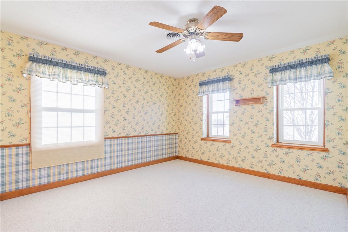 21389 North 2875 East Road Lexington, IL 61753 - Photo 32 of 44 an empty room with chandelier fan and windows