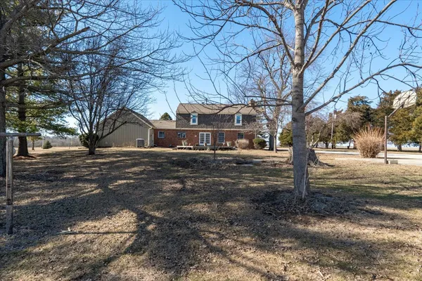 an empty room with windows and ceiling fan