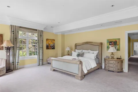 a spacious bedroom with a bed couch and a large window