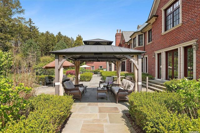 a view of a patio with table and chairs under an umbrella