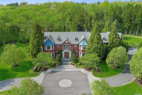 an aerial view of a house with yard and green space