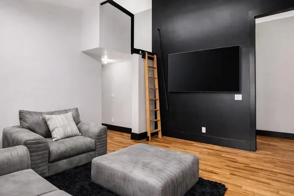 a bedroom with a bed and a large window