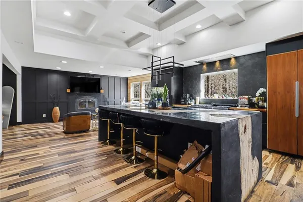 a kitchen with stainless steel appliances kitchen island granite countertop a refrigerator and a stove top oven