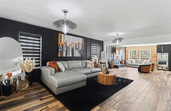 a kitchen with stainless steel appliances a stove a sink and a wooden floors