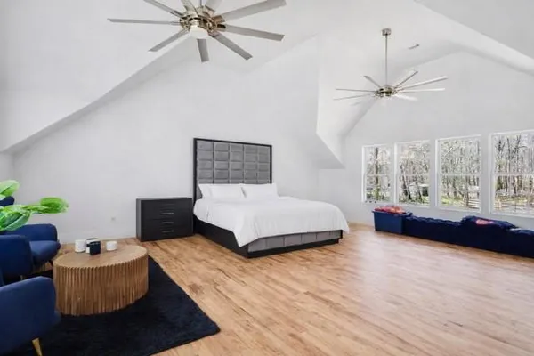 a bedroom with a bed and a flat screen tv