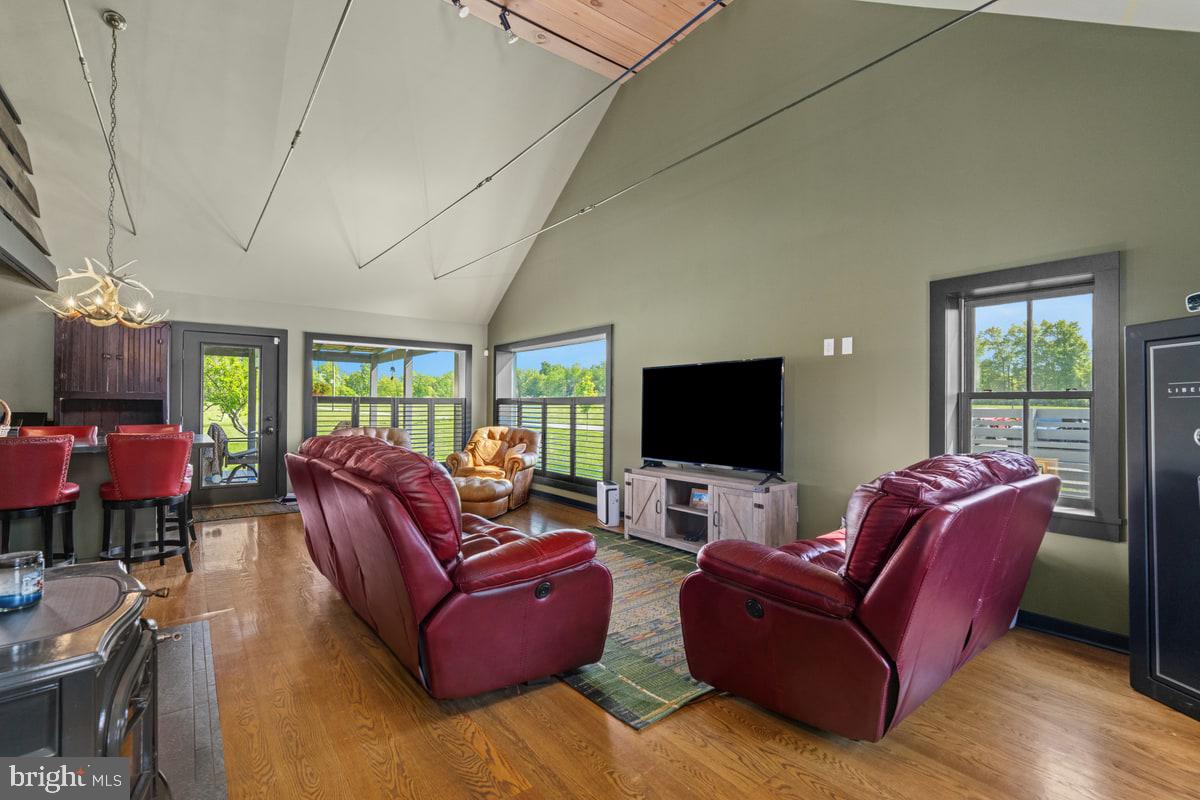 13 Rope Walk Road Upper Black Eddy, PA 18972 - Photo 20 of 40 a living room with furniture a flat screen tv and floor to ceiling window