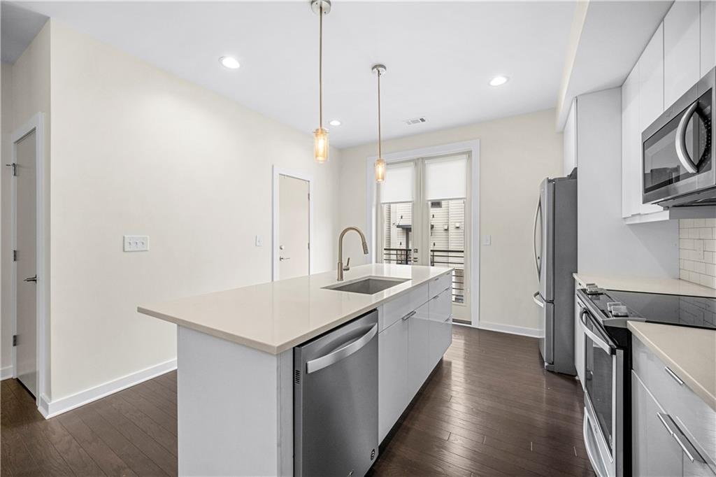 415 Gartrell Street Southeast, Unit 16 Atlanta, GA 30312 - Photo 11 of 29 a kitchen with white cabinets appliances and a sink