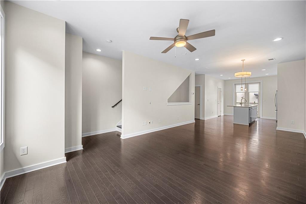 415 Gartrell Street Southeast, Unit 16 Atlanta, GA 30312 - Photo 13 of 29 a view of an empty room with wooden floor and a ceiling fan