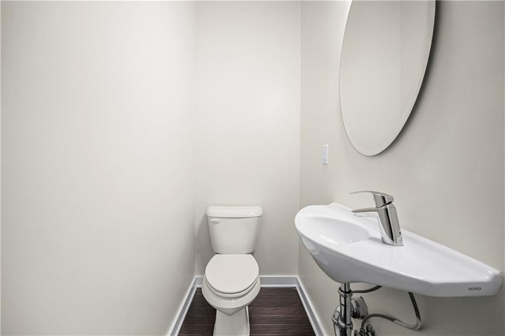 415 Gartrell Street Southeast, Unit 16 Atlanta, GA 30312 - Photo 14 of 29 a bathroom with a toilet sink and mirror