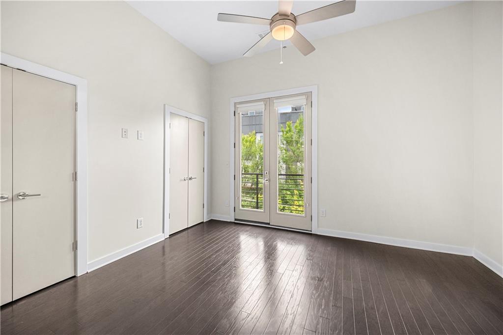 415 Gartrell Street Southeast, Unit 16 Atlanta, GA 30312 - Photo 18 of 29 an empty room with wooden floor fan and windows