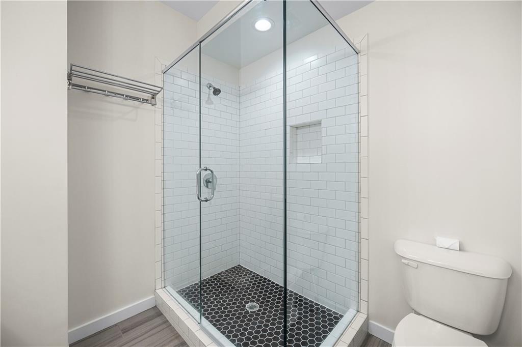 415 Gartrell Street Southeast, Unit 16 Atlanta, GA 30312 - Photo 21 of 29 a bathroom with a shower and a toilet