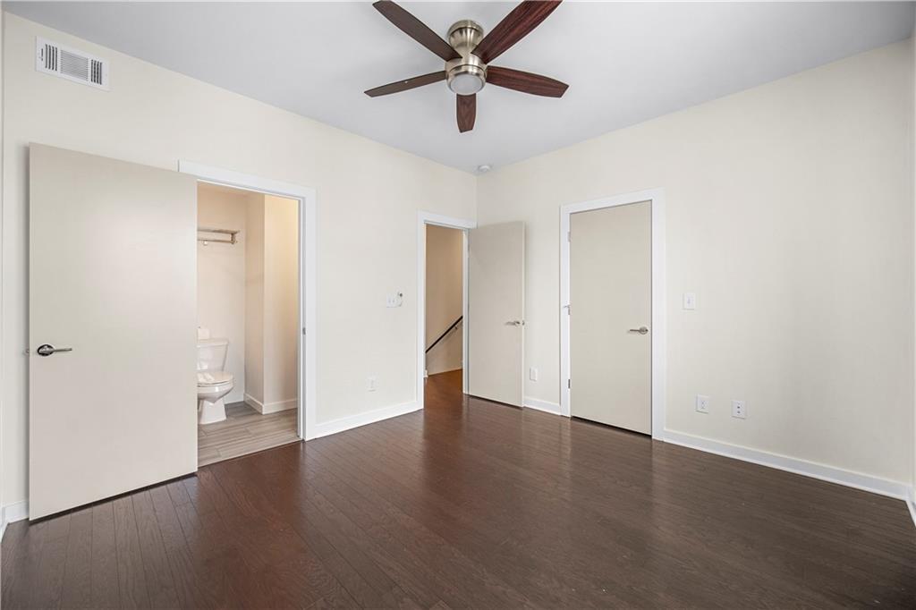 415 Gartrell Street Southeast, Unit 16 Atlanta, GA 30312 - Photo 23 of 29 an empty room with wooden floor and a ceiling fan