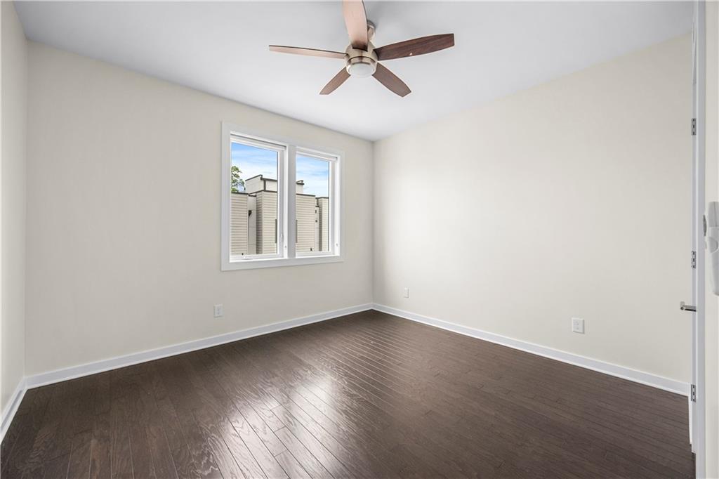 415 Gartrell Street Southeast, Unit 16 Atlanta, GA 30312 - Photo 24 of 29 an empty room with wooden floor ceiling fan and windows