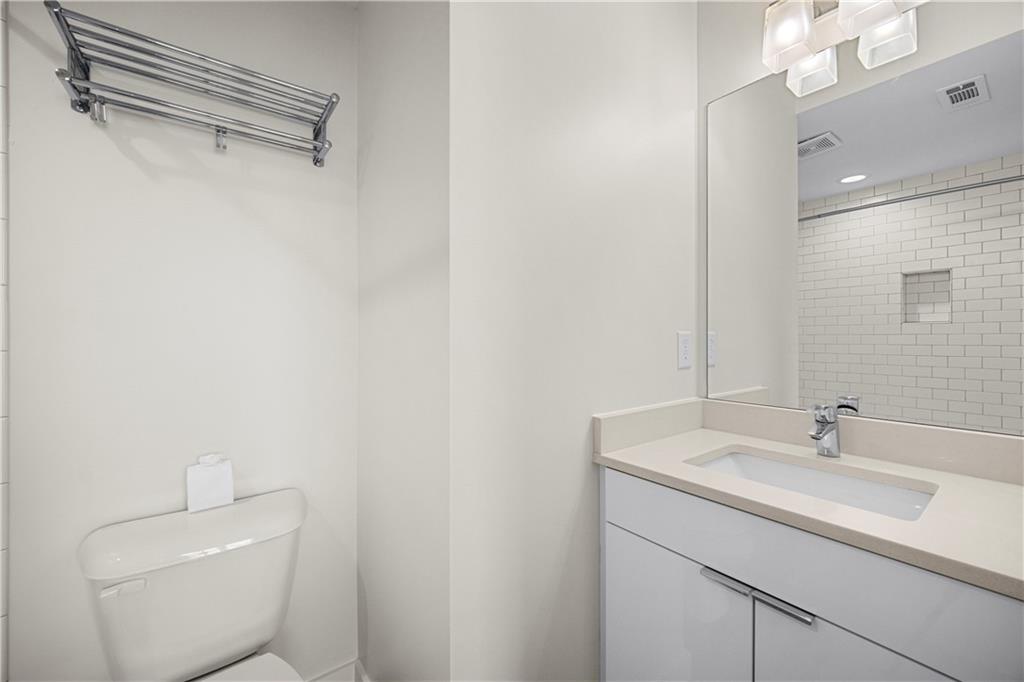415 Gartrell Street Southeast, Unit 16 Atlanta, GA 30312 - Photo 26 of 29 a bathroom with a sink a toilet and a mirror