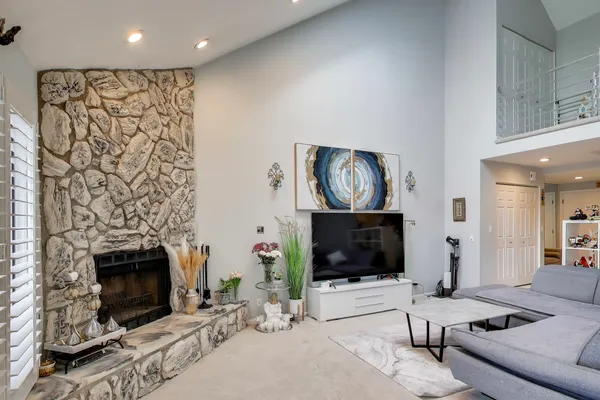 a living room with furniture and a fireplace