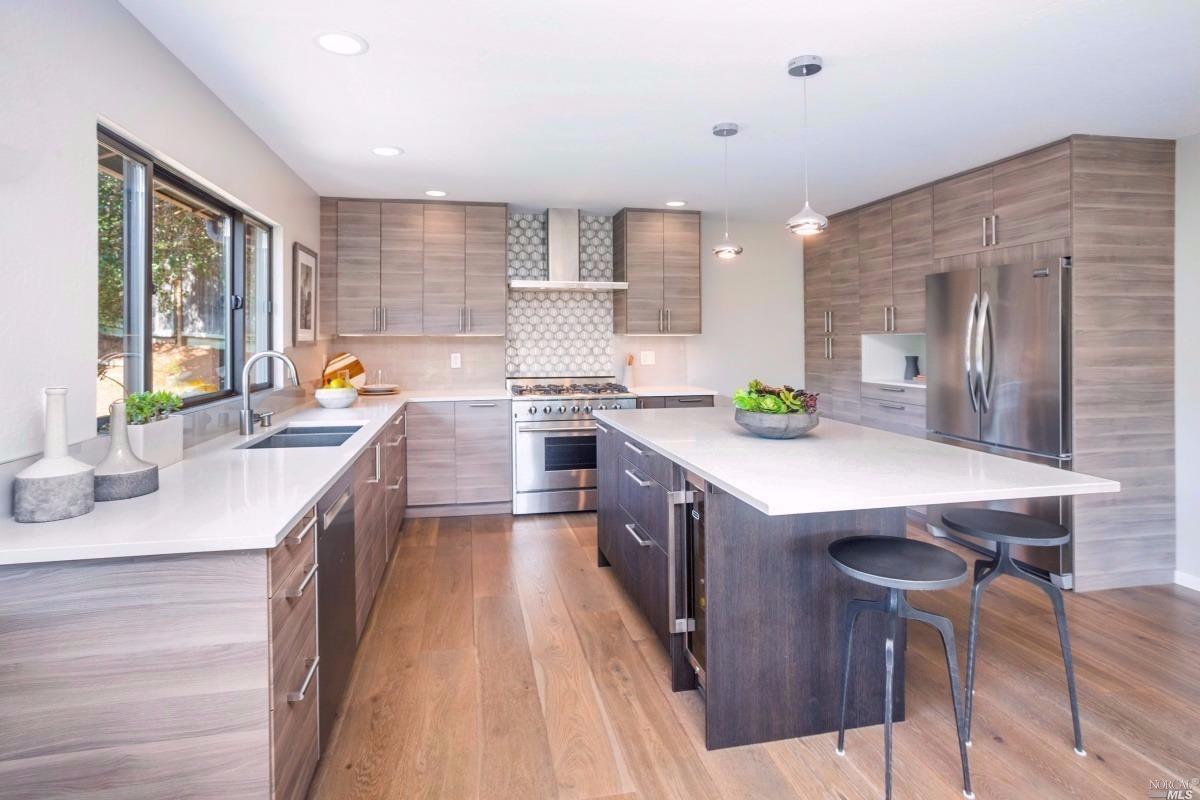 a kitchen with a sink a counter top space and stainless steel appliances