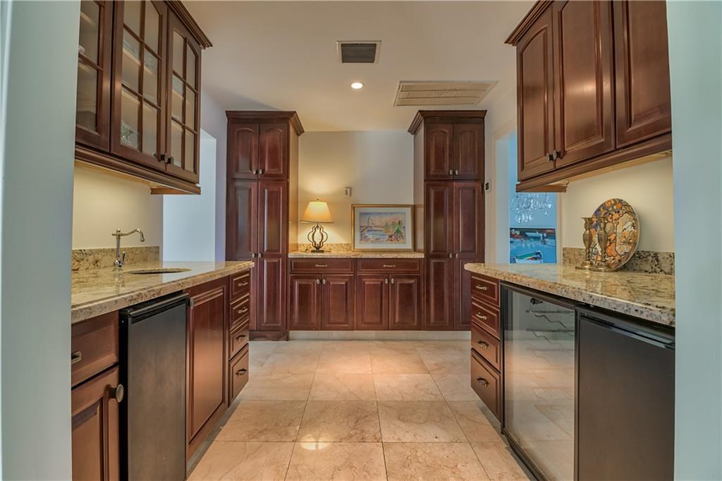 12 Heron's Nest Stuart, FL 34996 - Photo 15 of 43 a kitchen with stainless steel appliances granite countertop a refrigerator and a sink