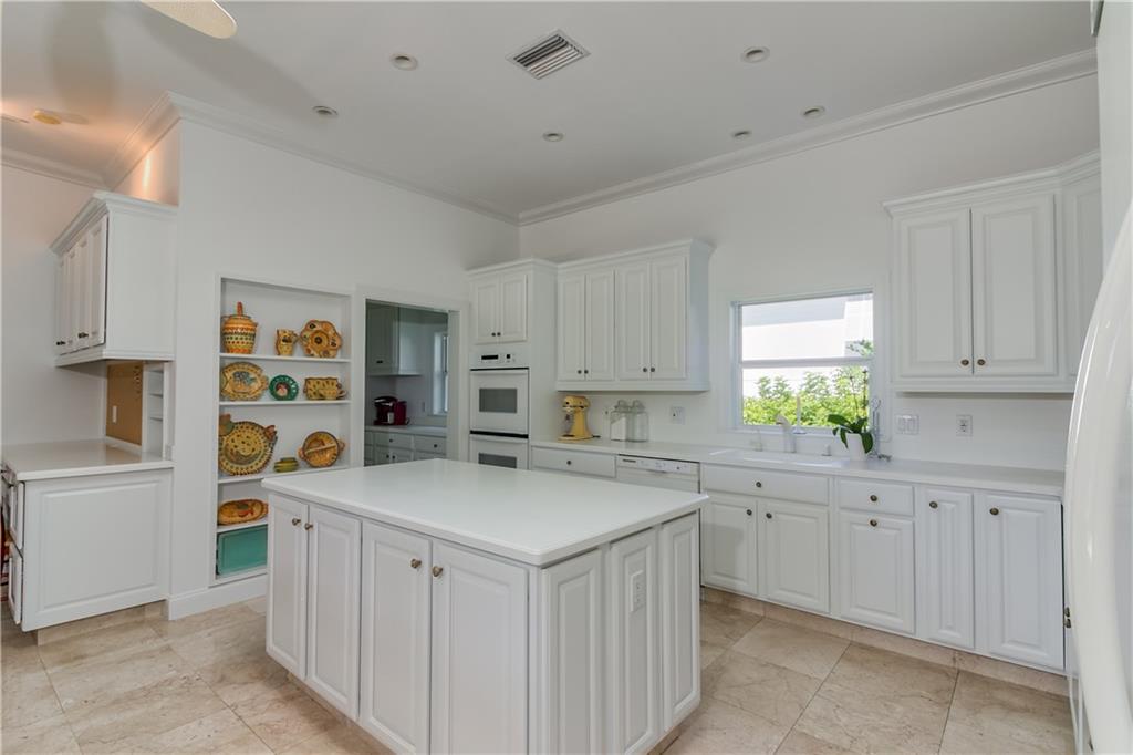12 Heron's Nest Stuart, FL 34996 - Photo 17 of 43 a kitchen with cabinets a sink and a window
