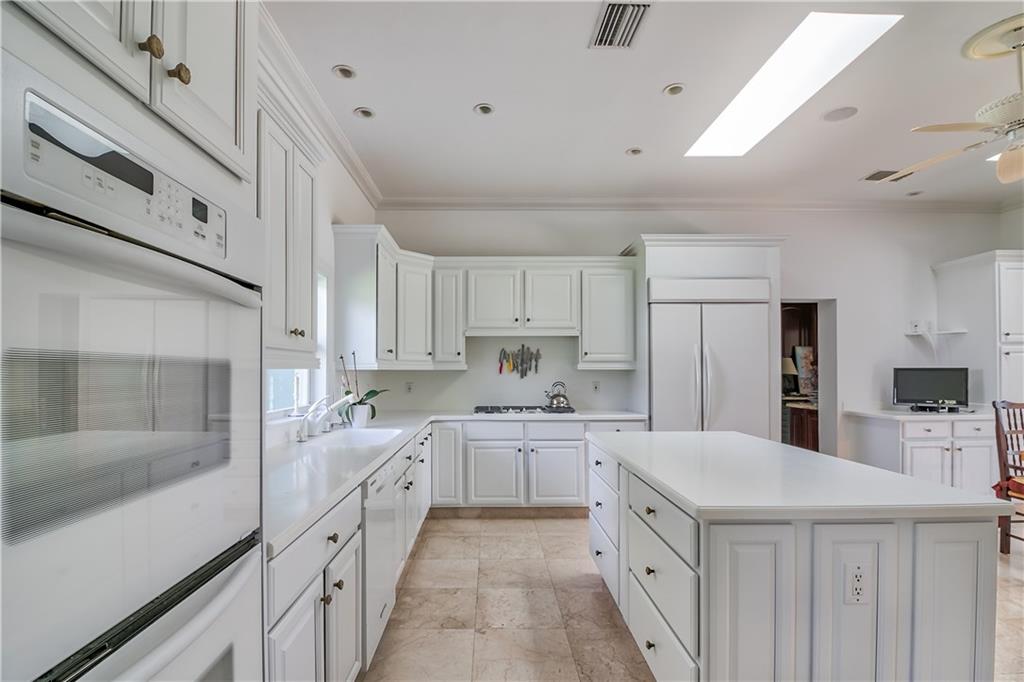 12 Heron's Nest Stuart, FL 34996 - Photo 18 of 43 a large kitchen with a lot of counter space and wooden floor