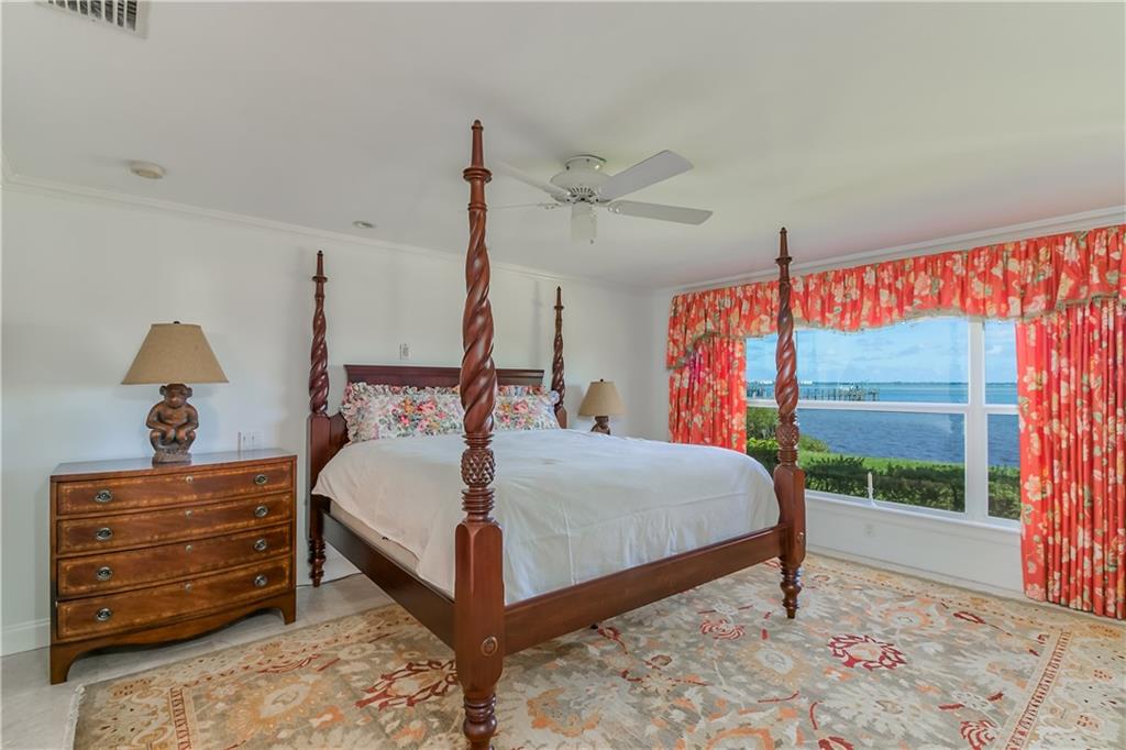 12 Heron's Nest Stuart, FL 34996 - Photo 27 of 43 a bed sitting in a bedroom next to a window