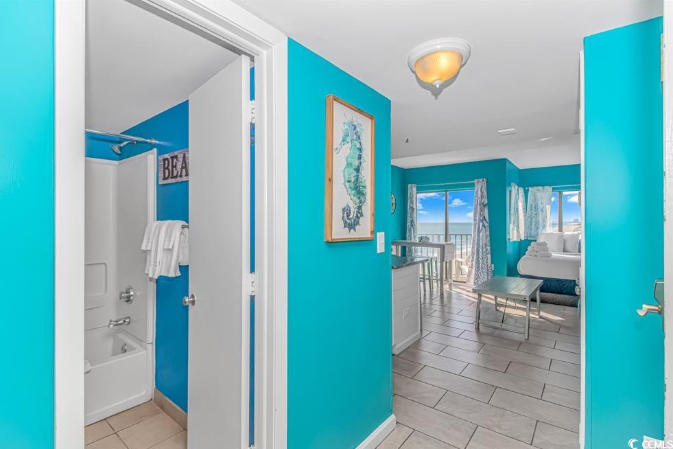 1605 South Ocean Boulevard, Unit 705 Myrtle Beach, SC 29577 - Photo 16 of 38 Corridor with light tile patterned floors and baseboards