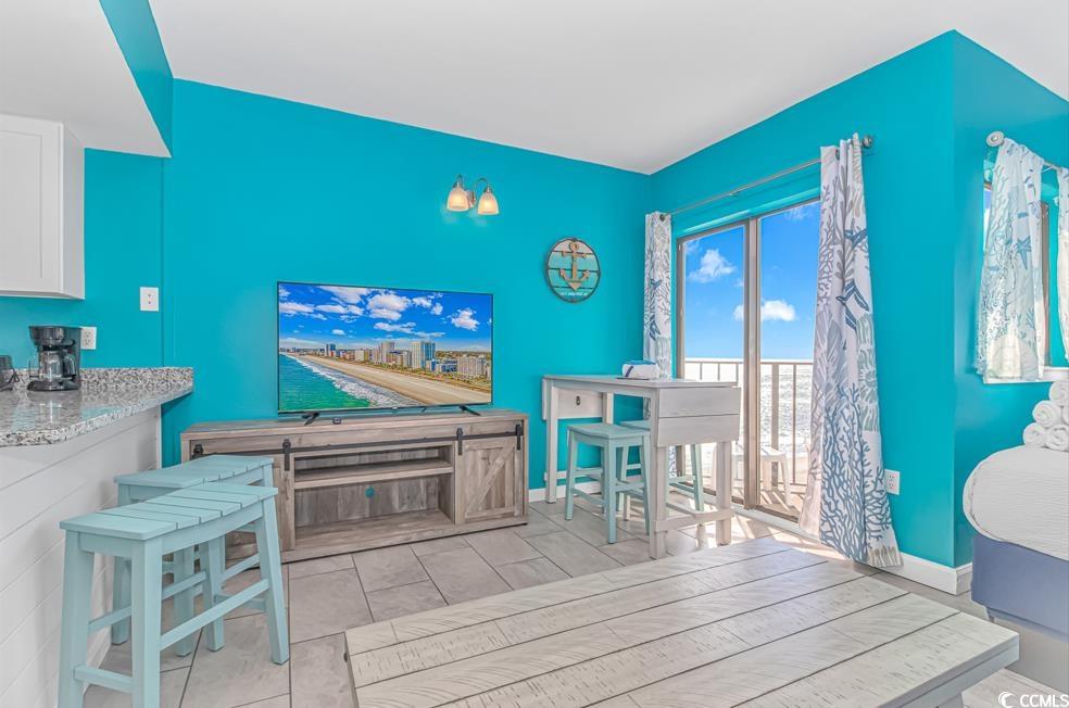 1605 South Ocean Boulevard, Unit 705 Myrtle Beach, SC 29577 - Photo 6 of 38 Interior space with light stone countertops and white cabinets