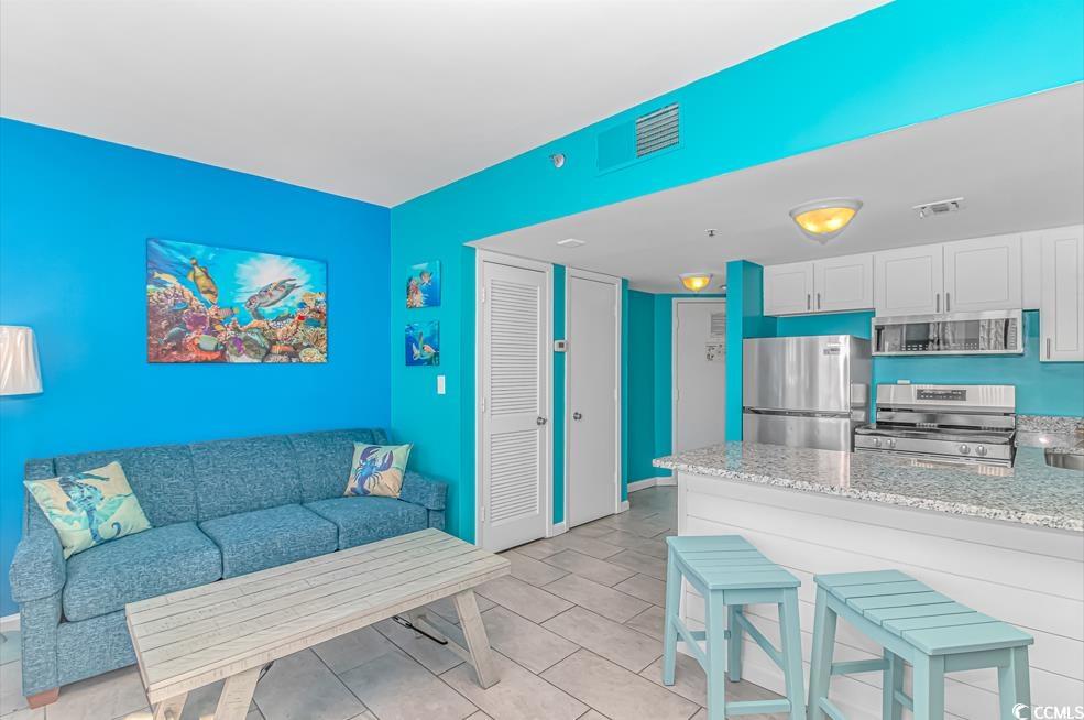 1605 South Ocean Boulevard, Unit 705 Myrtle Beach, SC 29577 - Photo 9 of 38 Living room with light tile patterned flooring