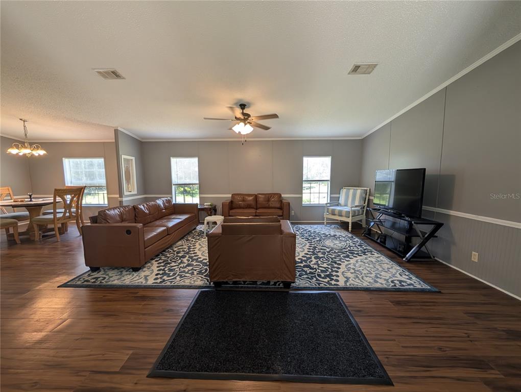 123 Amos Road Crescent City, FL 32112 - Photo 4 of 36 a living room with furniture and a flat screen tv
