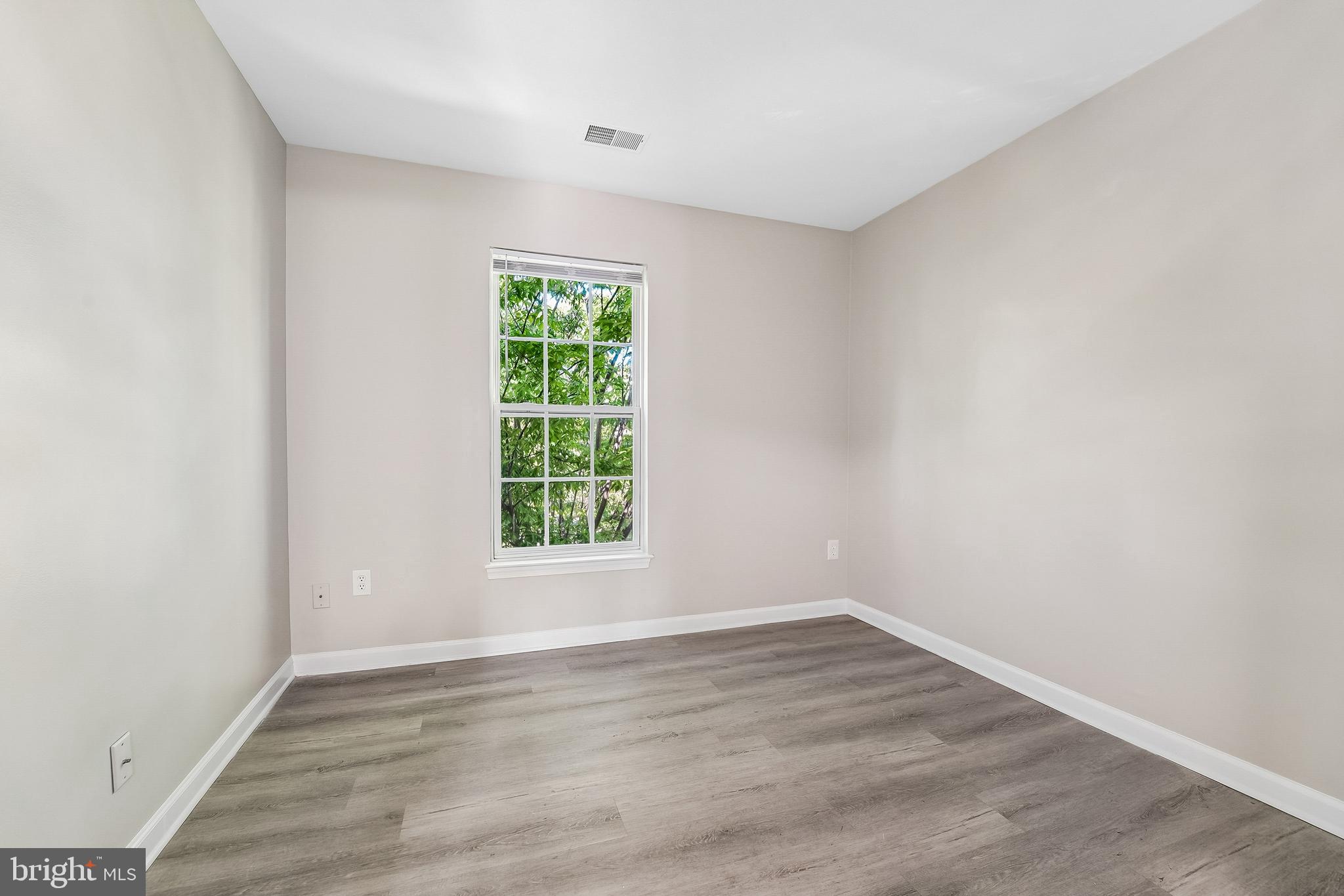 1461 Pangbourne Way Hanover, MD 21076 - Photo 27 of 51 an empty room with wooden floor and windows