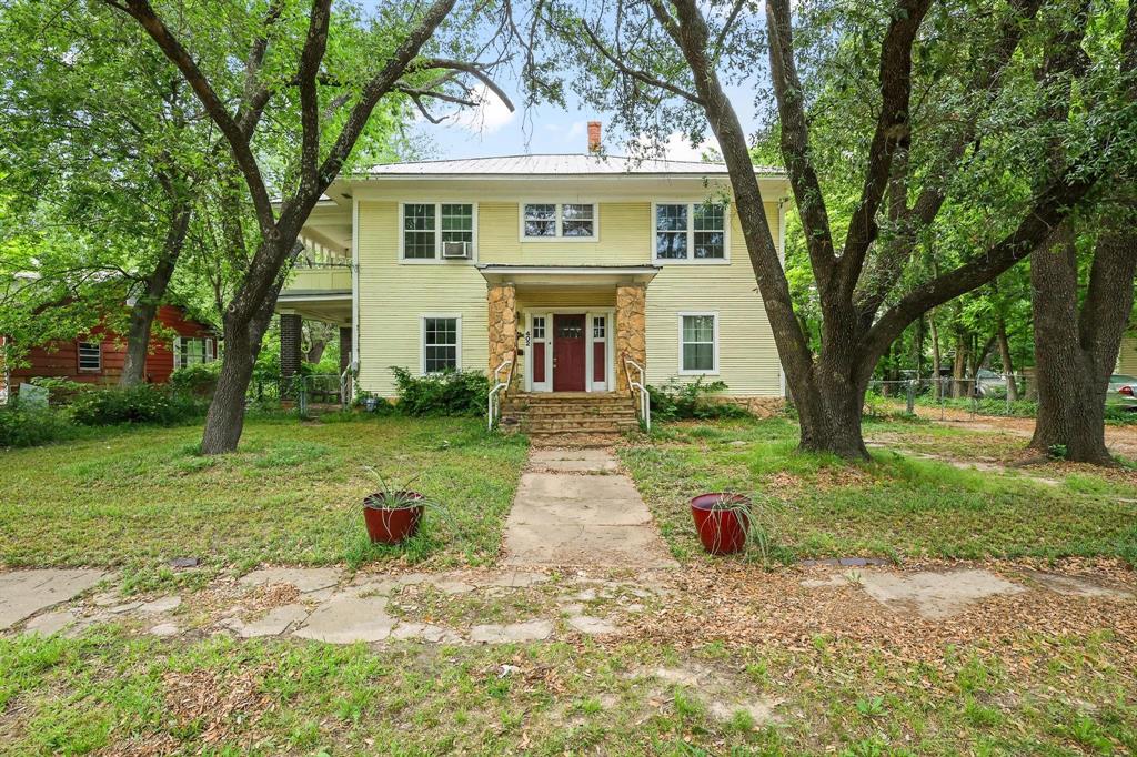 402 West Main Street Ladonia, TX 75449 - Photo 1 of 1 The property features a two-story exterior with yellow siding and a white roof
