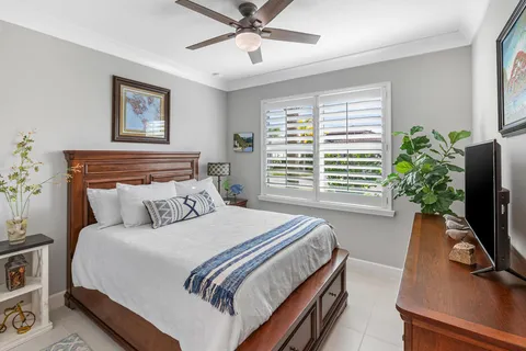 a living room with furniture a potted plant and a flat screen tv