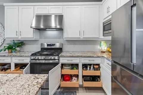 a living room with patio furniture and a potted plant
