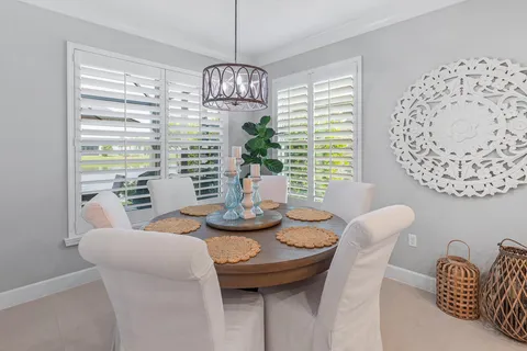 a living room with furniture a rug and a floor to ceiling window