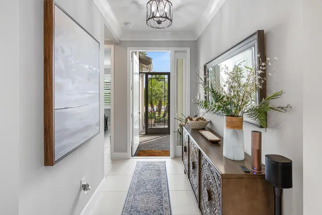 a kitchen with granite countertop kitchen island stainless steel appliances a stove top oven a sink a refrigerator white cabinets and wooden floor