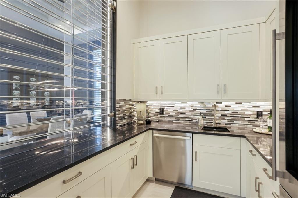 600 Gordonia Road Naples, FL 34108 - Photo 12 of 35 Butler's pantry with quartz countertops, wood cabinetry, dishwasher and built in refrigerator