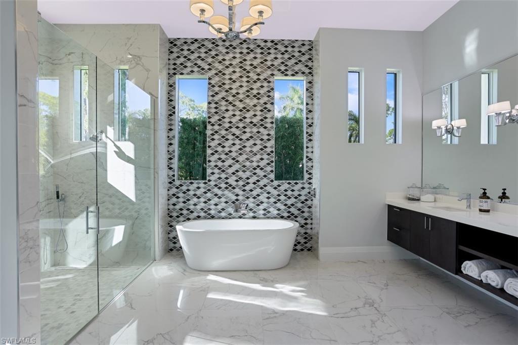 600 Gordonia Road Naples, FL 34108 - Photo 15 of 35 Master bathroom with separate glass enclosed shower, tub and dual sinks.
