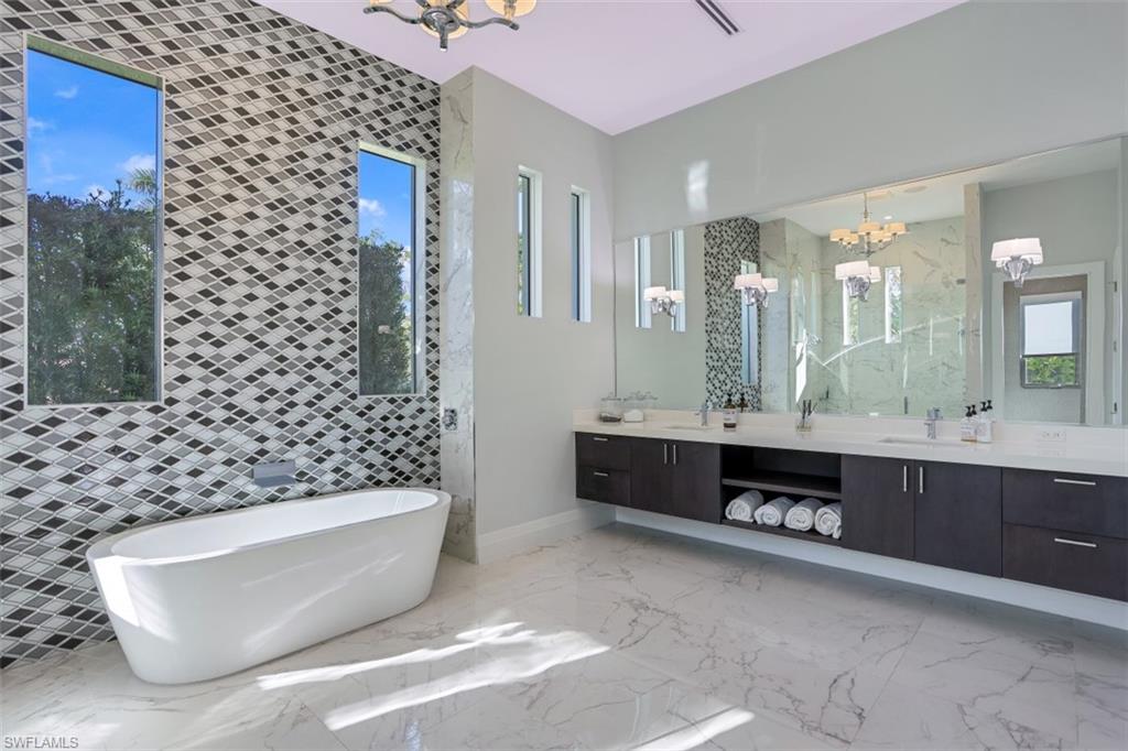 600 Gordonia Road Naples, FL 34108 - Photo 16 of 35 Dual sinks with quartz countertops and soaking tub.
