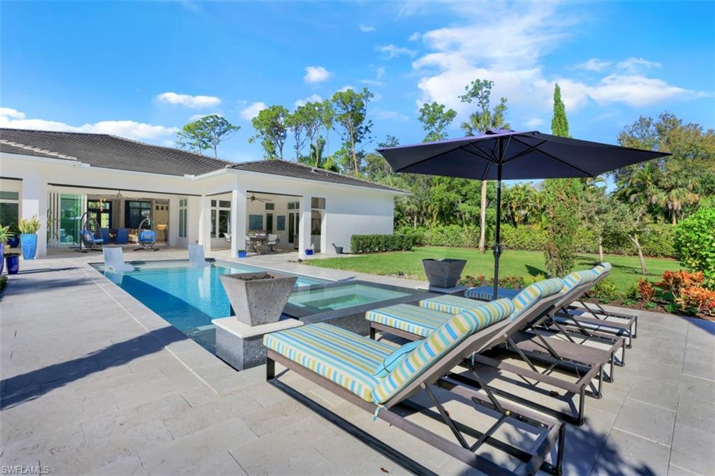 600 Gordonia Road Naples, FL 34108 - Photo 31 of 35 Outdoor area with pool, spa and fire bowls.