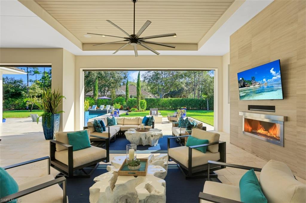 600 Gordonia Road Naples, FL 34108 - Photo 4 of 35 Outdoor entertaining area with outdoor fireplace and TV