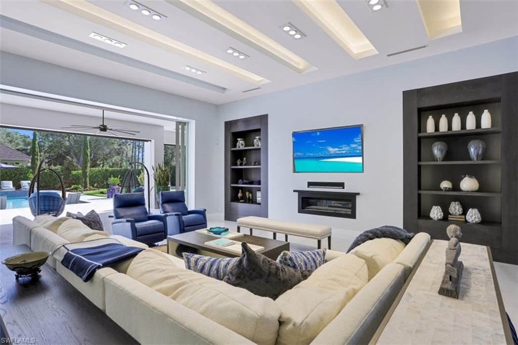 600 Gordonia Road Naples, FL 34108 - Photo 7 of 35 Great room with built-in storage, gas fireplace and TV/Sonos