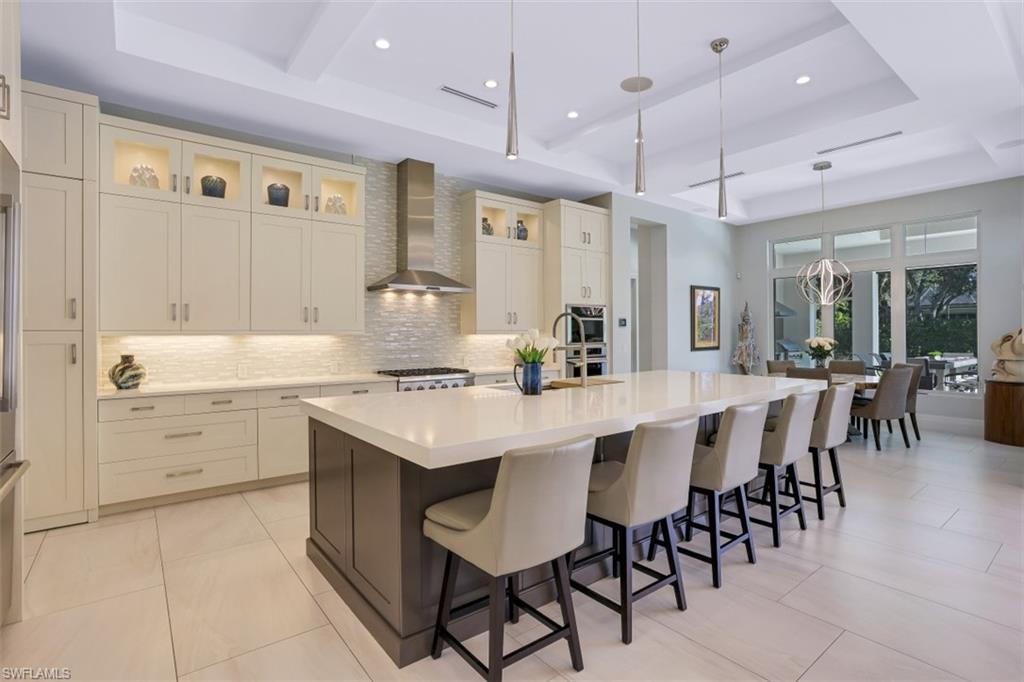 600 Gordonia Road Naples, FL 34108 - Photo 9 of 35 Gourmet kitchen with quartz countertops, custom backsplash, lighting and Thermador appliances.