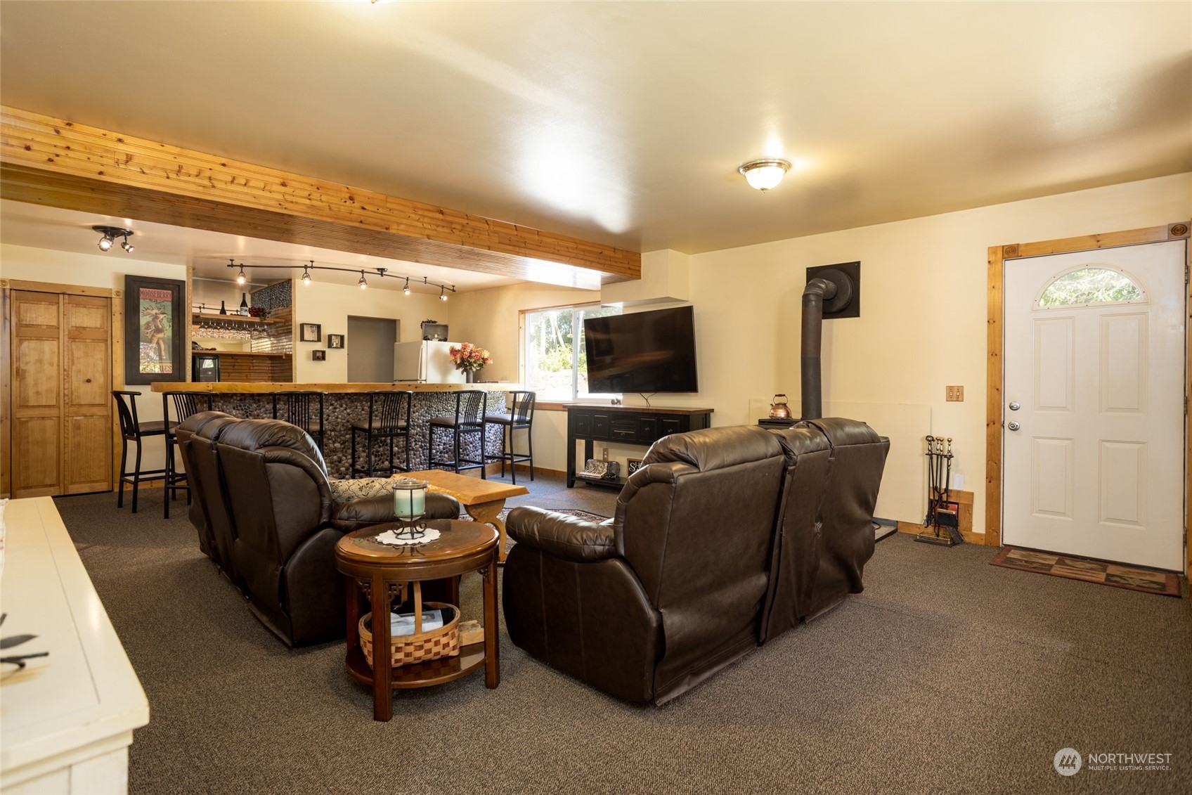 23627 Hoogdal Road Sedro-Woolley, WA 98284 - Photo 13 of 39 a living room with furniture a flat screen tv and kitchen view