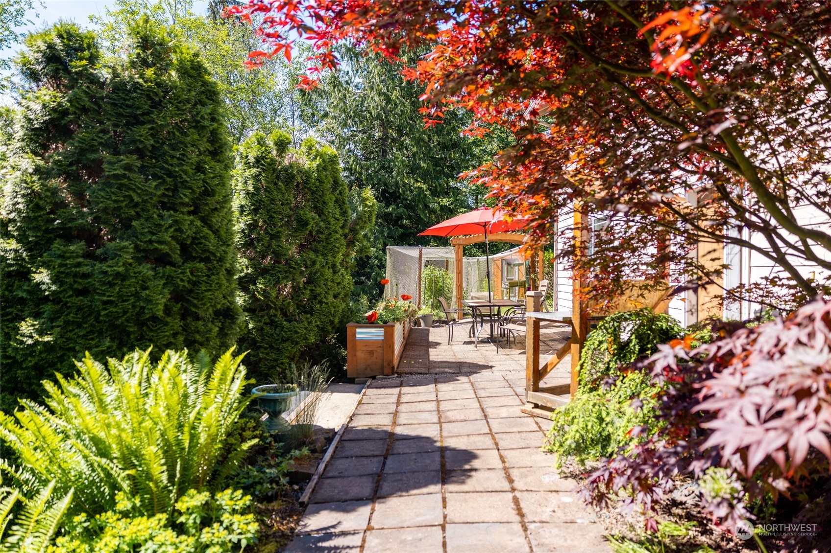 23627 Hoogdal Road Sedro-Woolley, WA 98284 - Photo 4 of 39 a view of a patio with table and chairs and potted plants